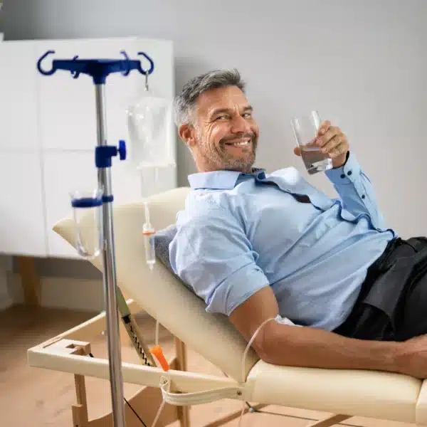 Nurse administering home IV infusion therapy
