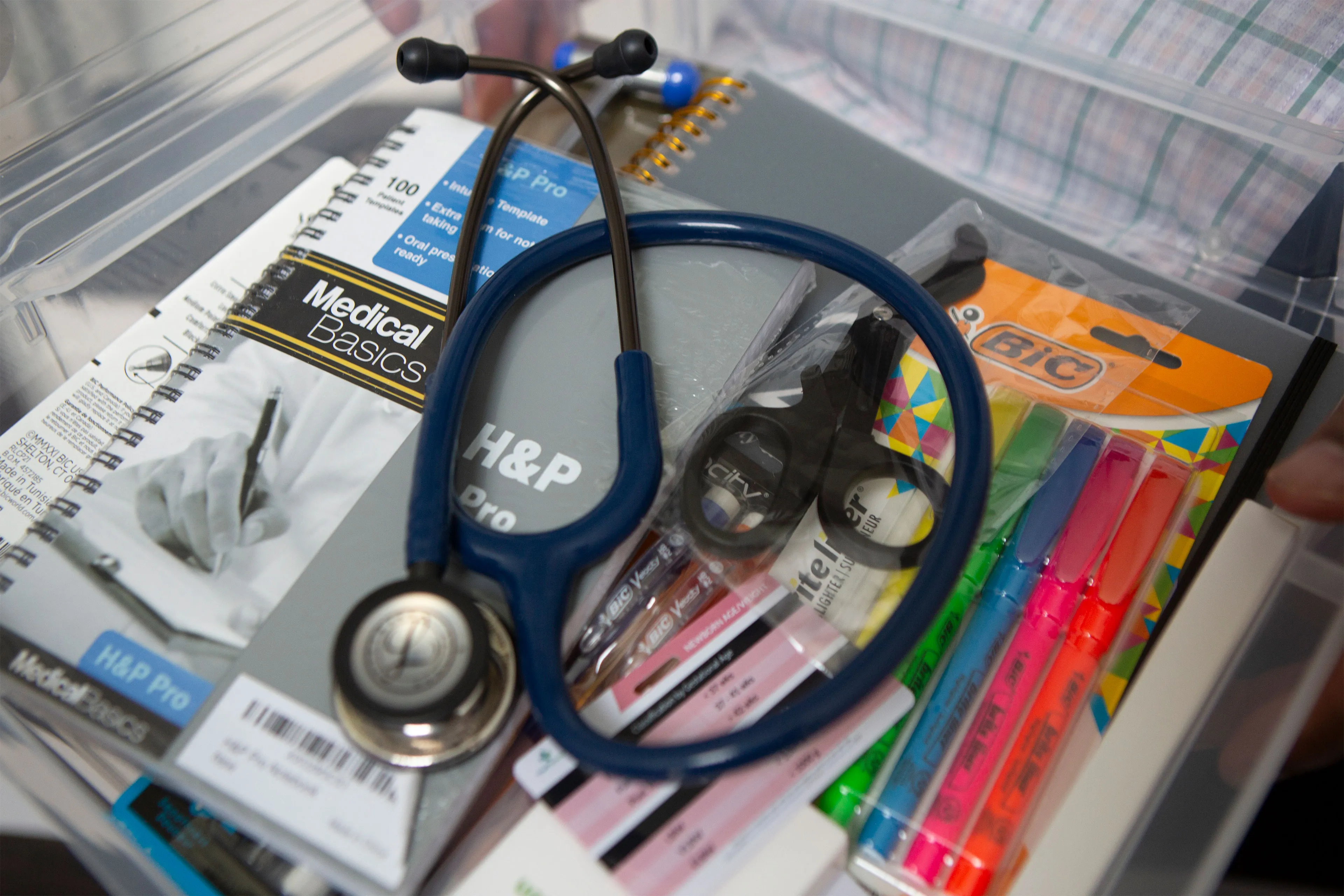 Inside Pinckney's "PA School Starter Kit": a stethoscope, a medical notebook, a set of highlighters, scissors.